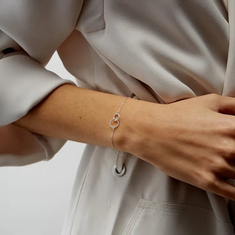 Das „Sleek Circles“-Armband in elegantem Silber überzeugt mit seinem minimalistischen Doppelkreis-Design aus robustem Edelstahl. Die klaren Linien und die hochwertige Verarbeitung betonen das zeitlose Erscheinungsbild des Schmuckstücks. Ideal für den täglichen Gebrauch und als stilvolles Geschenk – „Sleek Circles“ verleiht jedem Outfit einen dezenten, aber wirkungsvollen Akzent.